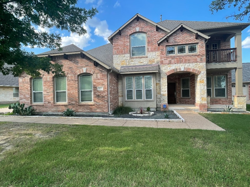 a front view of a house with a yard