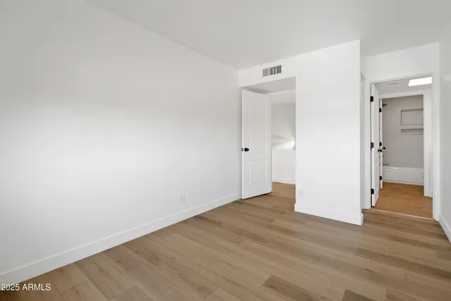 a view of hallway with stairs and wooden floor