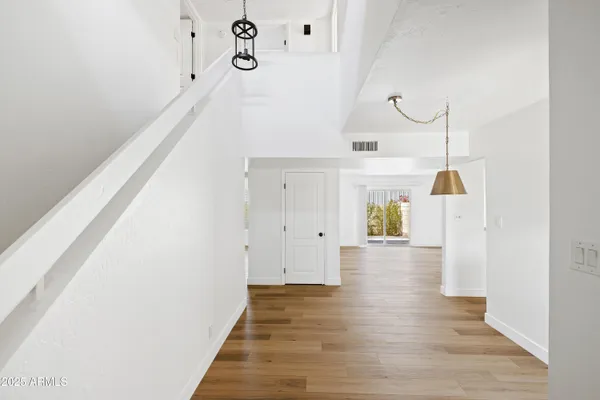 a view of a living room with furniture and wooden floor