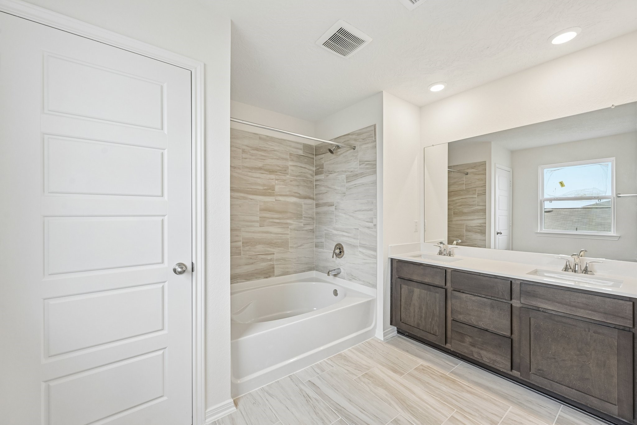 2503 Spruce Hl Road Beasley, TX 77417 - Photo 15 of 25 This stunning primary bathroom is truly move-in ready! It features stained cabinetry with light countertops, dual sinks, a large mirror, high ceilings, custom paint, a large window, and sleek modern finishes throughout.