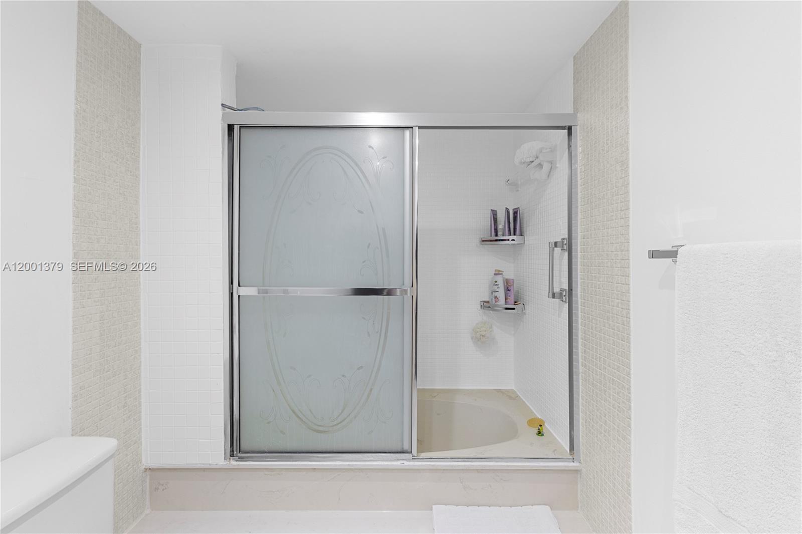 16251 Golf Club Road, Unit 311 Weston, FL 33326 - Photo 18 of 38 a bathroom with a glass shower door