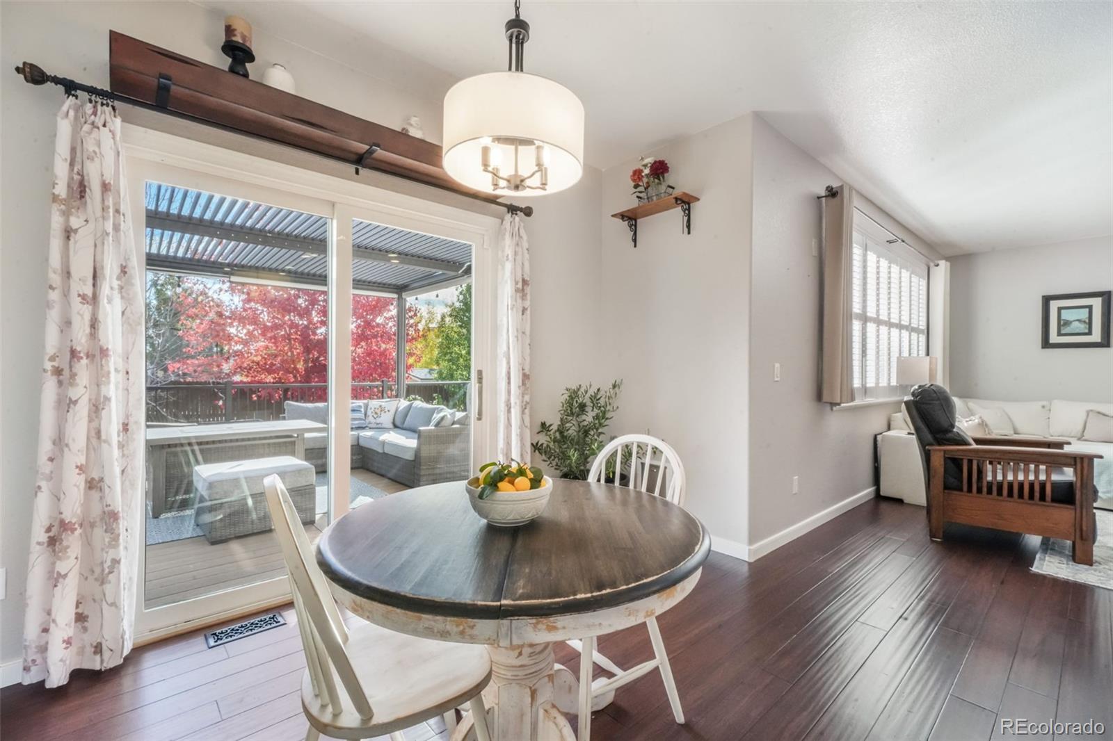 4457 Centerville Drive Colorado Springs, CO 80922 - Photo 16 of 50 a view of a dining room with furniture wooden floor and chandelier