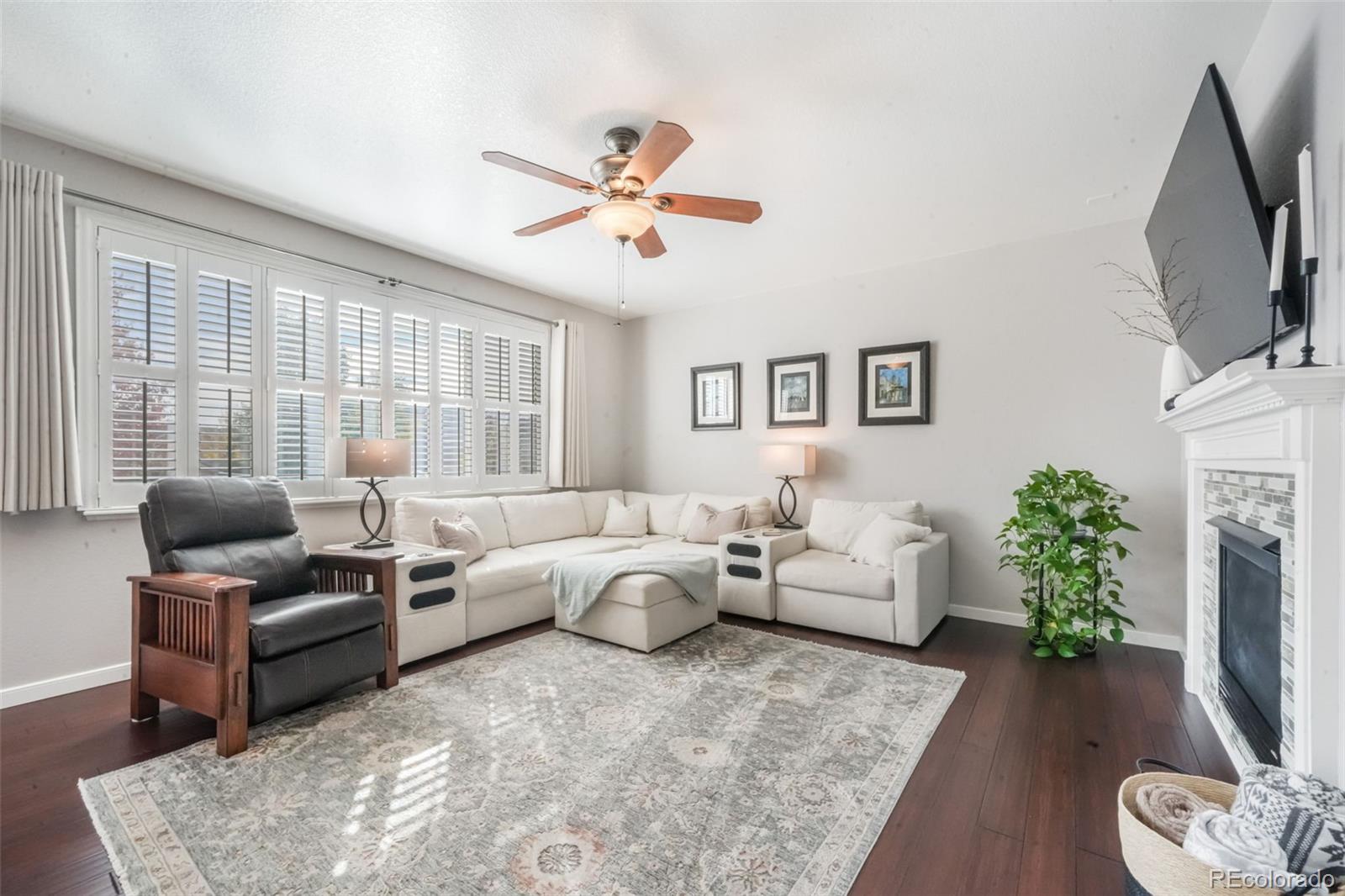 4457 Centerville Drive Colorado Springs, CO 80922 - Photo 20 of 50 a living room with furniture fireplace and flat screen tv