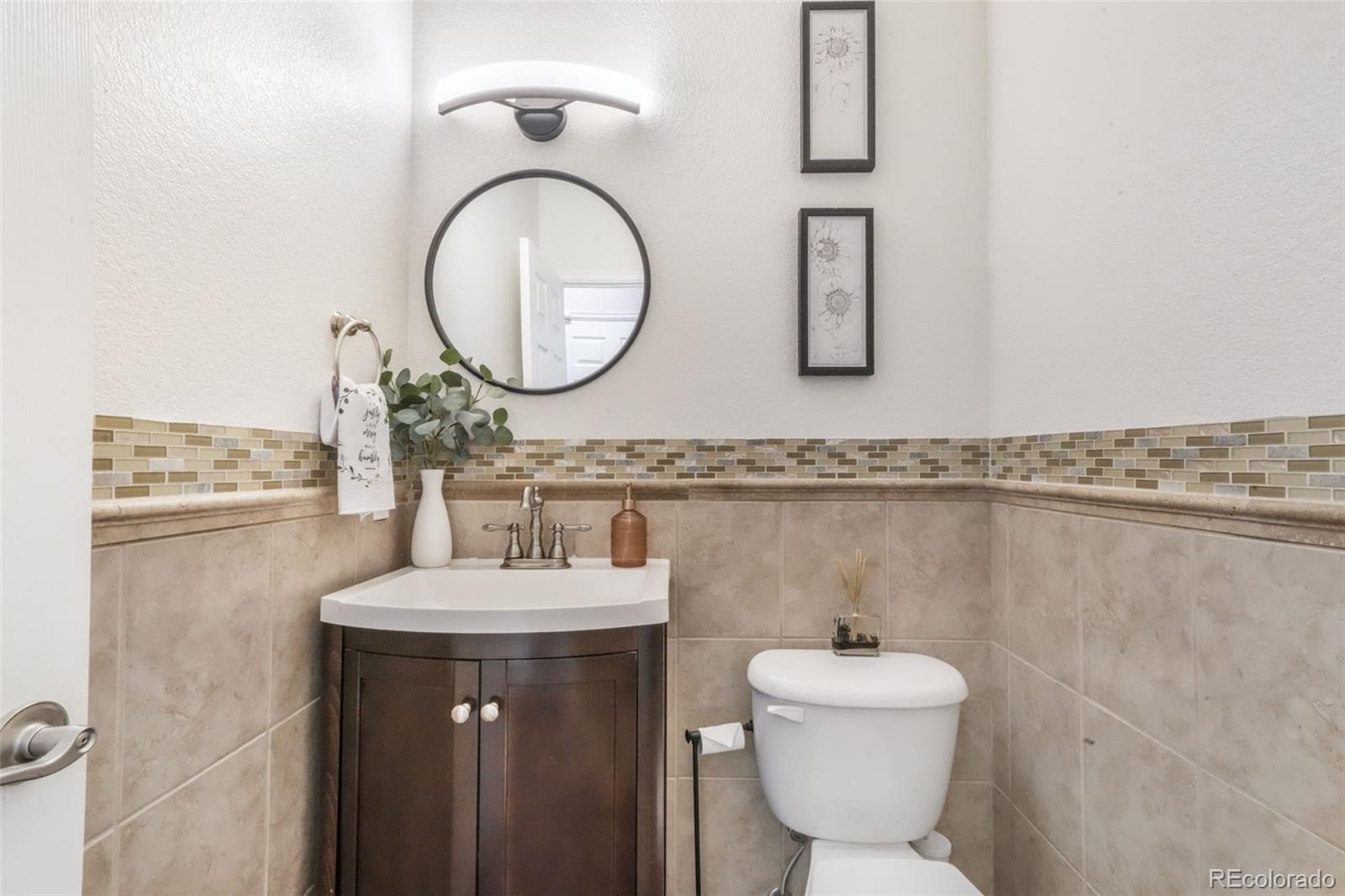4457 Centerville Drive Colorado Springs, CO 80922 - Photo 23 of 50 a bathroom with a sink mirror and toilet