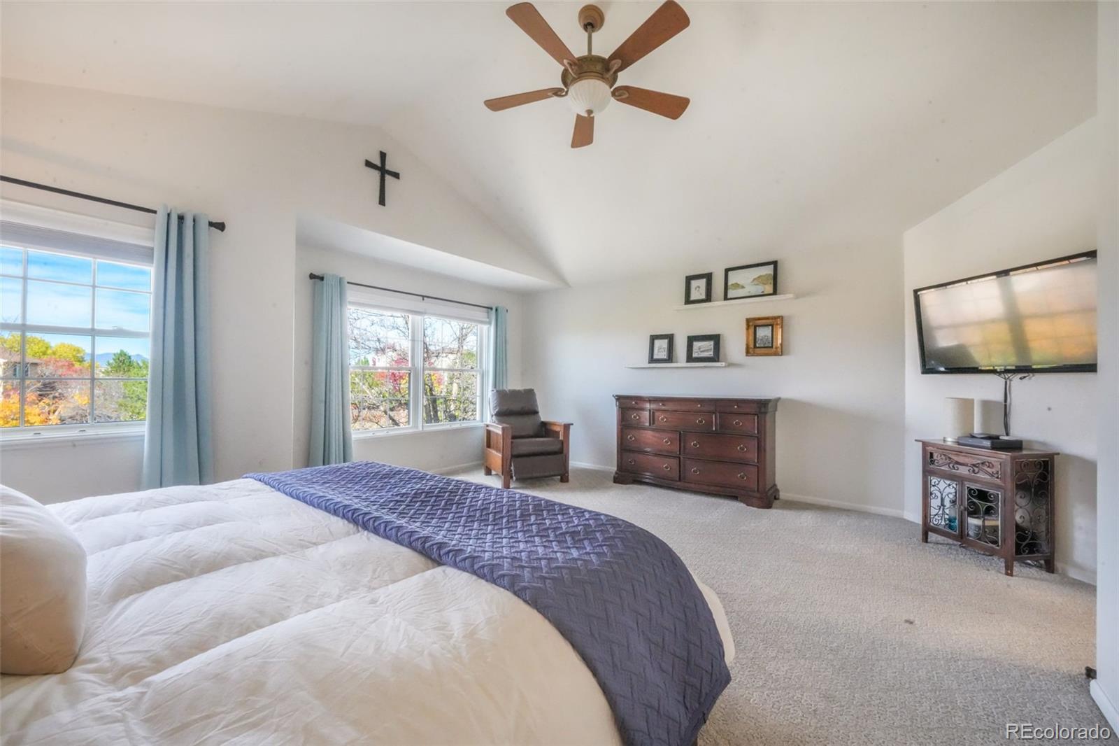 4457 Centerville Drive Colorado Springs, CO 80922 - Photo 25 of 50 a spacious bedroom with a bed and a flat screen television