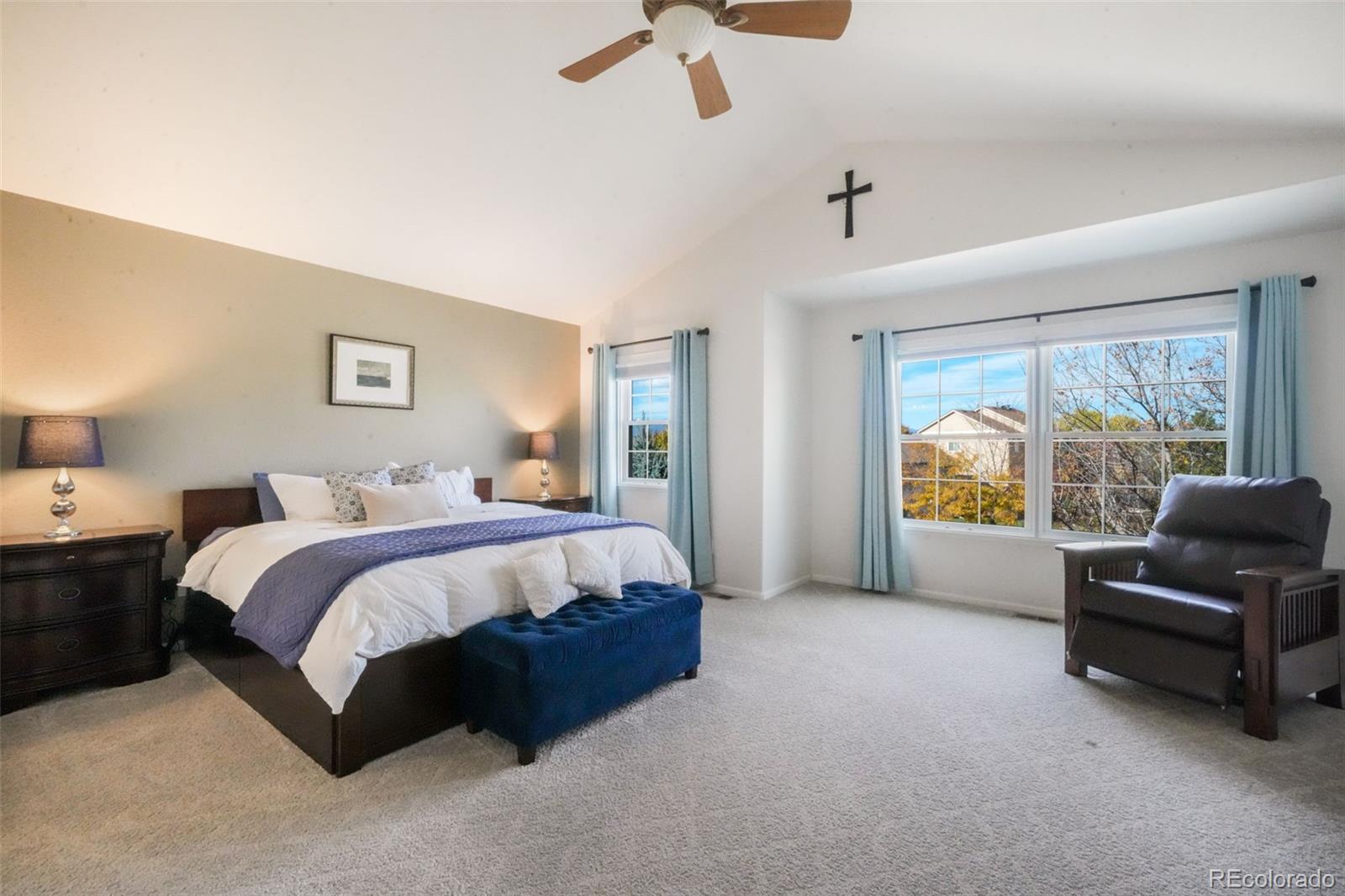 4457 Centerville Drive Colorado Springs, CO 80922 - Photo 26 of 50 a spacious bedroom with a bed and a couch