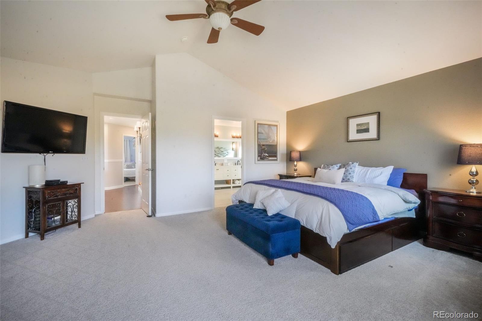 4457 Centerville Drive Colorado Springs, CO 80922 - Photo 27 of 50 a spacious bedroom with a bed and a television in it