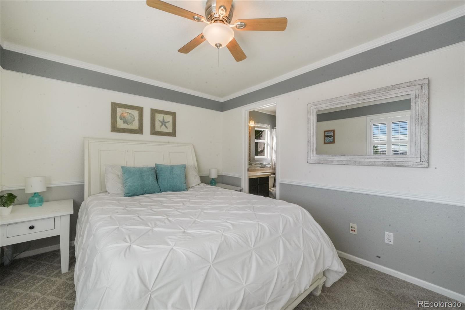 4457 Centerville Drive Colorado Springs, CO 80922 - Photo 34 of 50 a bedroom with a bed and a chandelier