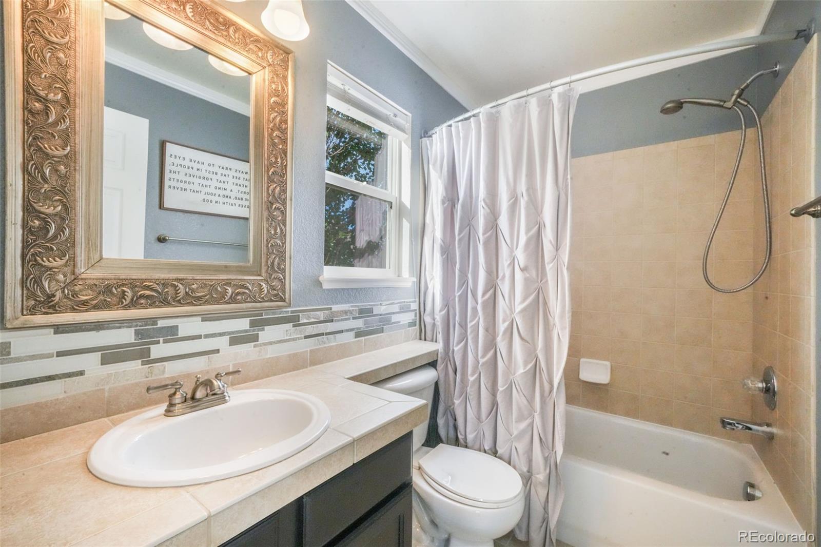 4457 Centerville Drive Colorado Springs, CO 80922 - Photo 35 of 50 a bathroom with a sink toilet and shower