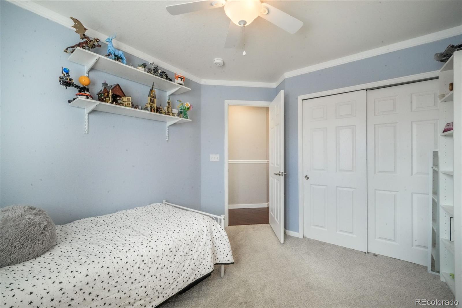 4457 Centerville Drive Colorado Springs, CO 80922 - Photo 36 of 50 a bedroom with a bed and cabinets