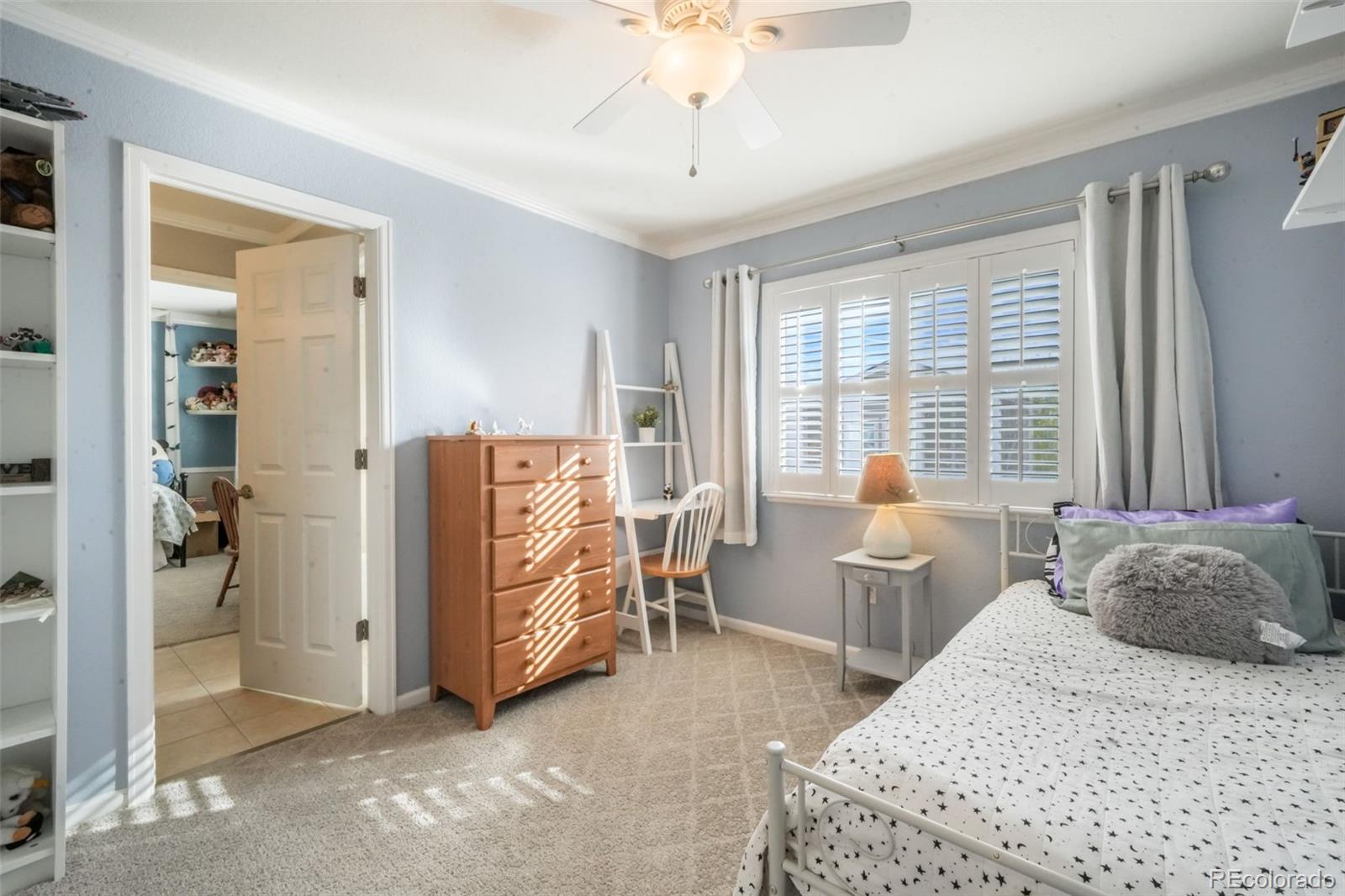 4457 Centerville Drive Colorado Springs, CO 80922 - Photo 37 of 50 a bedroom with a bed and large windows