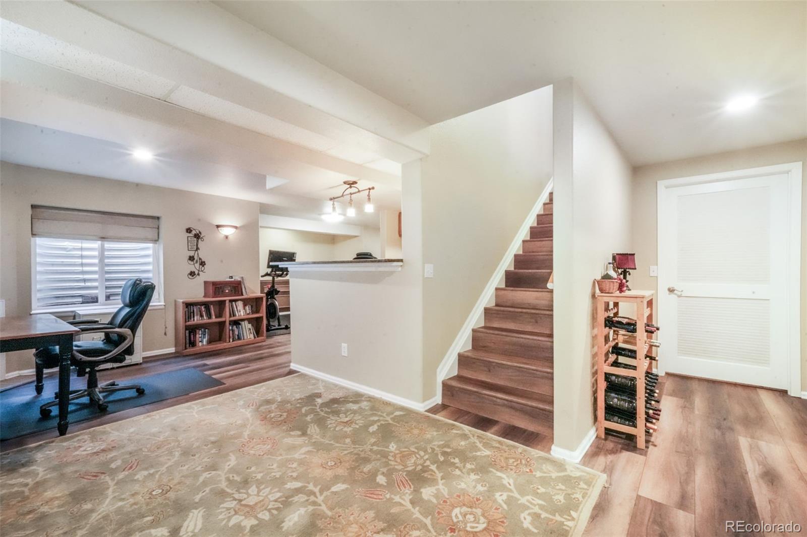 4457 Centerville Drive Colorado Springs, CO 80922 - Photo 42 of 50 a view of a livingroom with wooden furniture and staircase