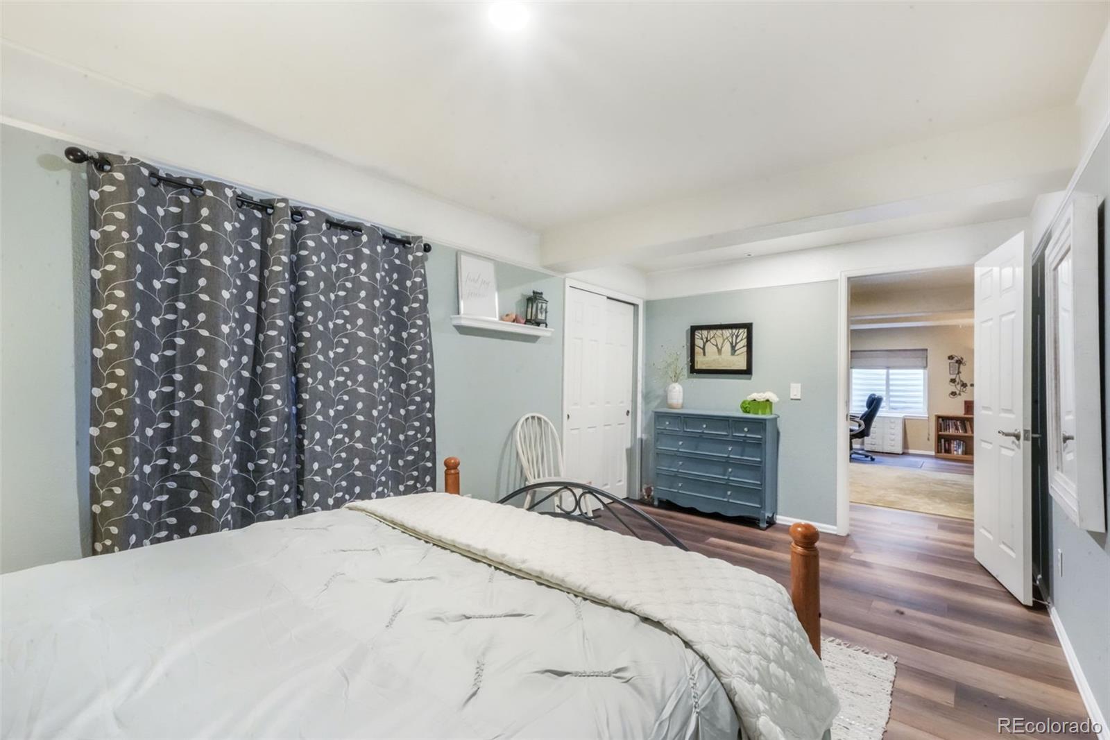 4457 Centerville Drive Colorado Springs, CO 80922 - Photo 49 of 50 a bedroom with a bed and wooden floor