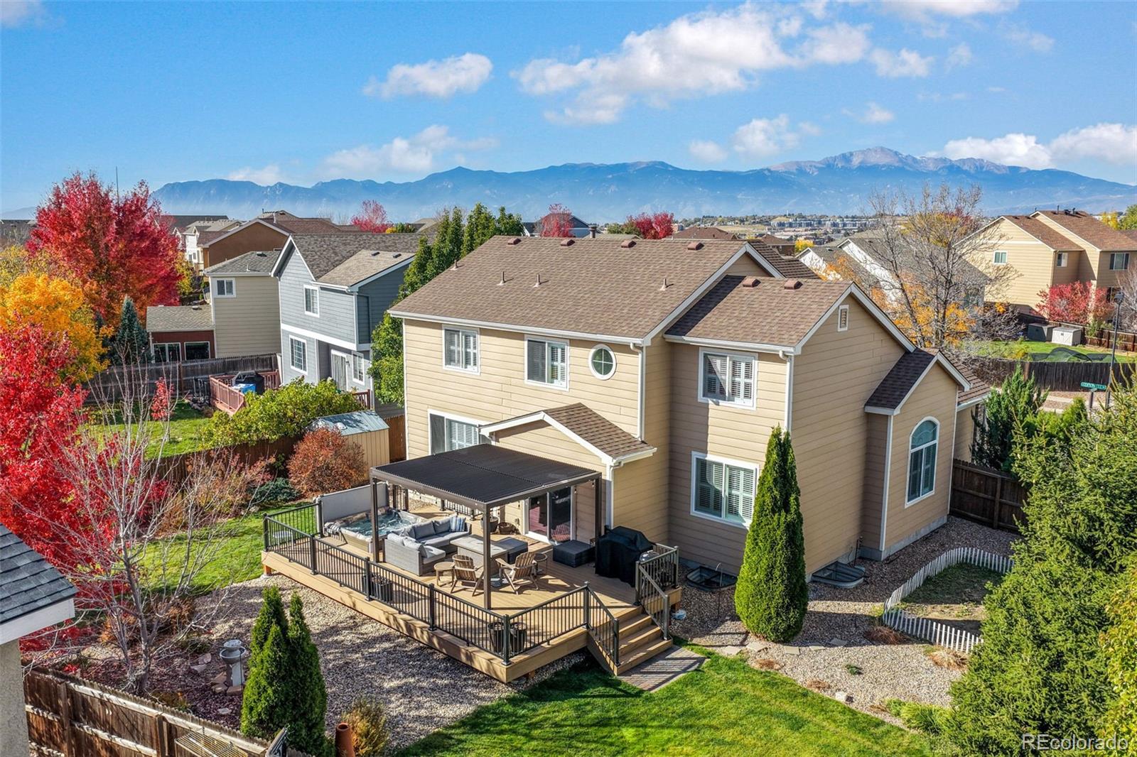 4457 Centerville Drive Colorado Springs, CO 80922 - Photo 5 of 50 a aerial view of a house with table and chairs under an umbrella
