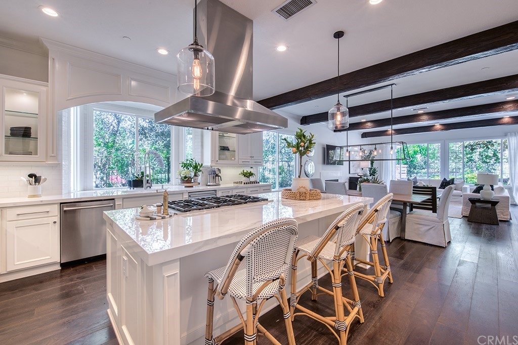 4 Black Walnut Coto de Caza, CA 92679 - Photo 11 of 39 a kitchen with stainless steel appliances granite countertop a stove a sink dishwasher and a dining table with the living room