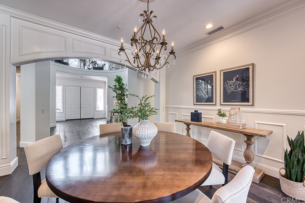 4 Black Walnut Coto de Caza, CA 92679 - Photo 7 of 39 a dining room with wooden floor a chandelier a wooden table and chairs