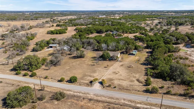 an aerial view of a house with a yard