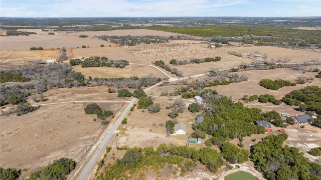 an aerial view of a house with a yard and garden