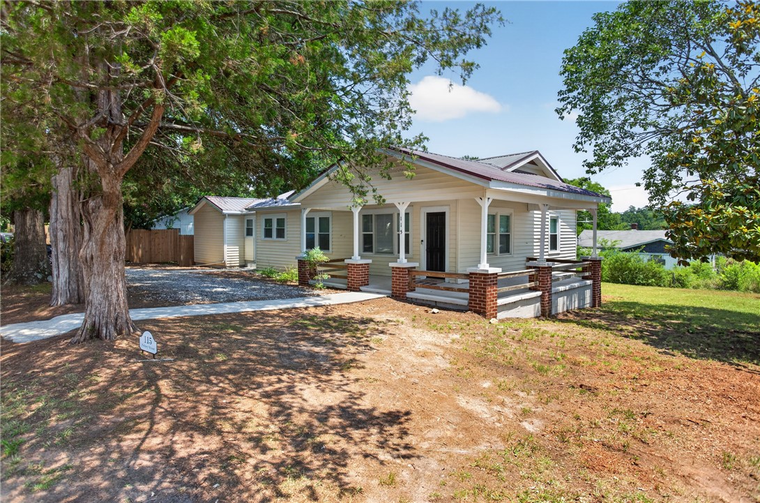 115 Pelfrey Street Seneca, SC 29672 - Photo 1 of 46 A charming single-story residence boasts a welcoming covered front porch, brick accents, and mature trees shading the yard.