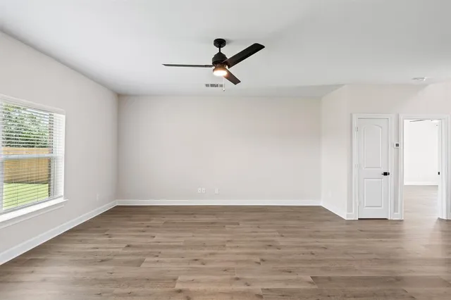 a view of room with window and hardwood floor