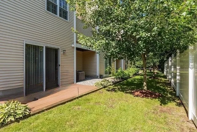 a view of backyard of house with green space