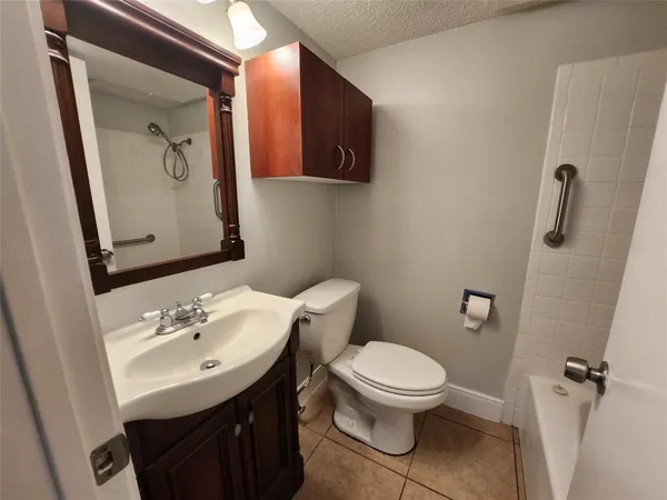 a bathroom with a sink toilet and mirror