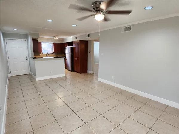 a view of kitchen with furniture and refrigerator