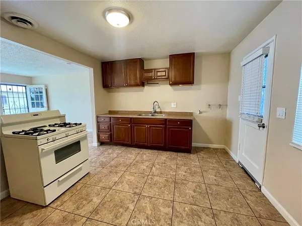 a kitchen with stainless steel appliances a stove a sink and a refrigerator