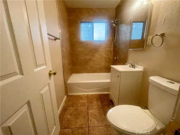 a bathroom with a toilet and a bathtub