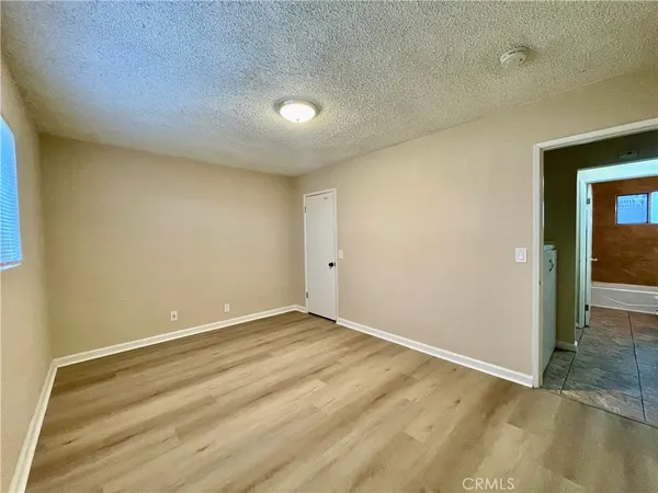 an empty room with wooden floor