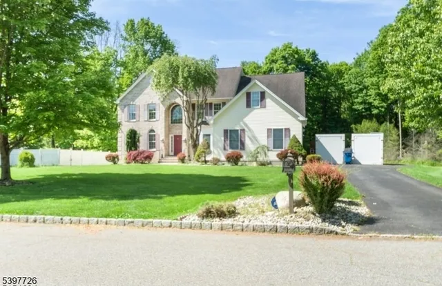a view of a house with a yard and a garden
