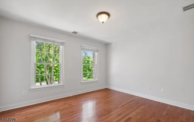 a view of hallway with wooden floor