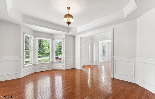 a view of a livingroom with wooden floor and a fireplace