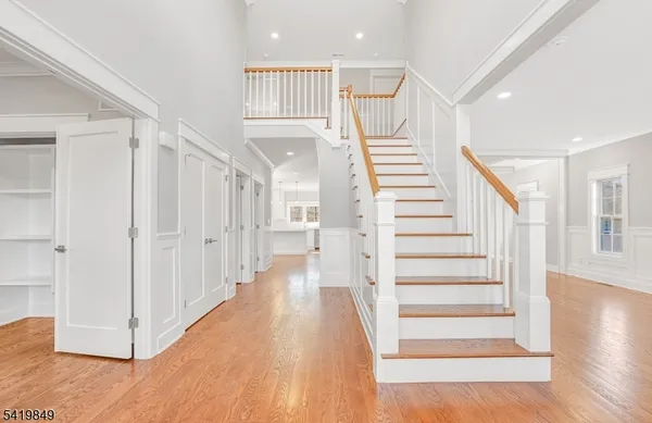 a view of entryway with wooden floor and stairs