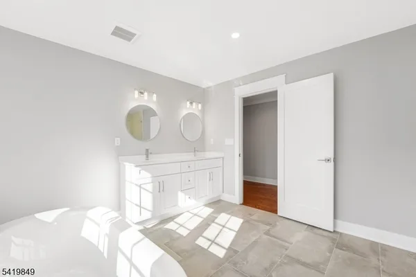 a view of a bathroom with sink and mirror