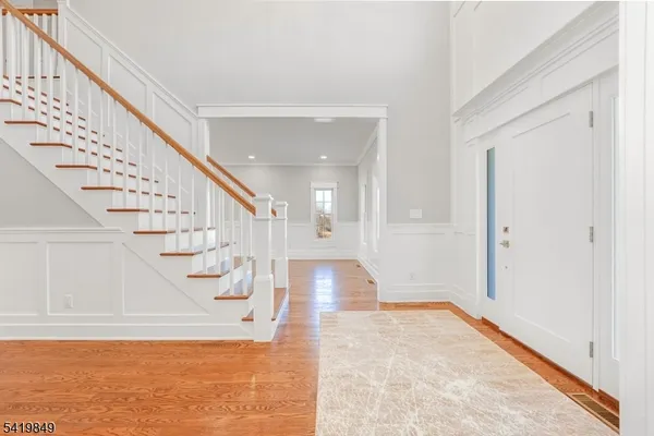 a view of entryway and hall with wooden floor