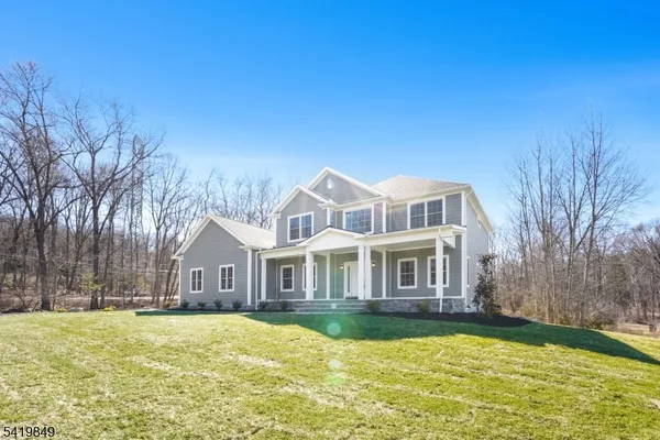 a aerial view of a house with swimming pool next to a yard