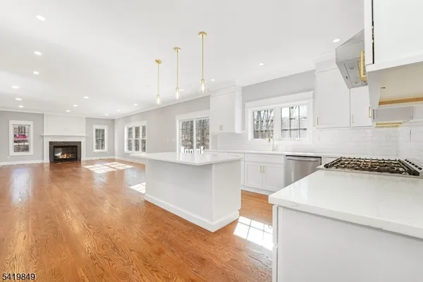a kitchen with a sink a stove and cabinets