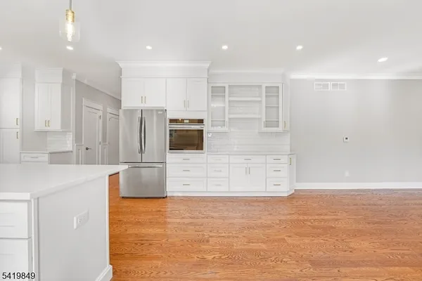 a view of cabinets with stainless steel appliances kitchen island