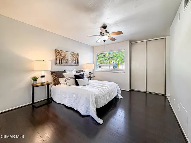 a spacious bedroom with a bed and a chandelier