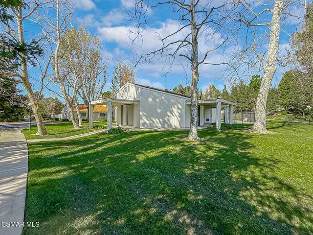 a view of a swimming pool and trees in the background