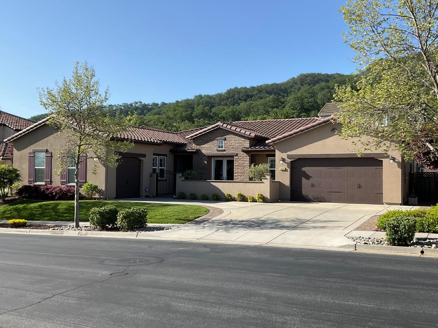a front view of a house with a garden