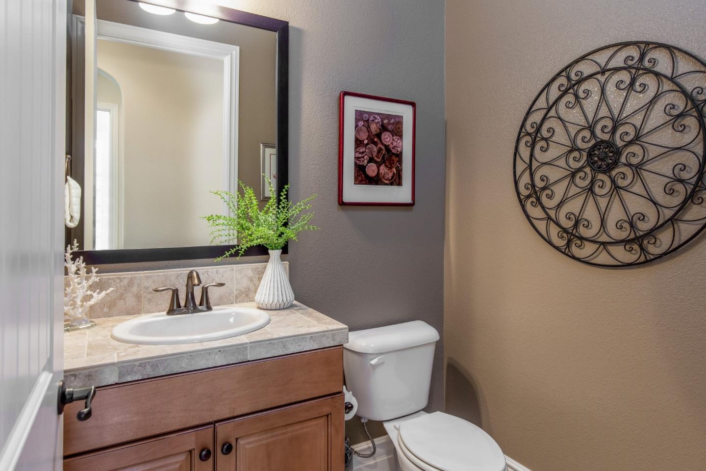 7217 Pitlochry Drive Gilroy, CA 95020 - Photo 21 of 66 a bathroom with a toilet sink and mirror