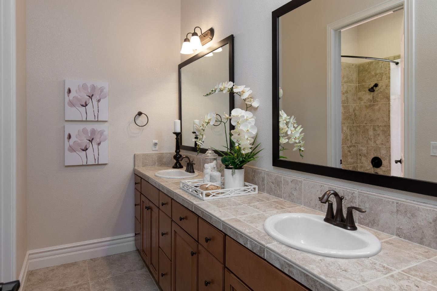 7217 Pitlochry Drive Gilroy, CA 95020 - Photo 24 of 66 a bathroom with a granite countertop sink and a mirror