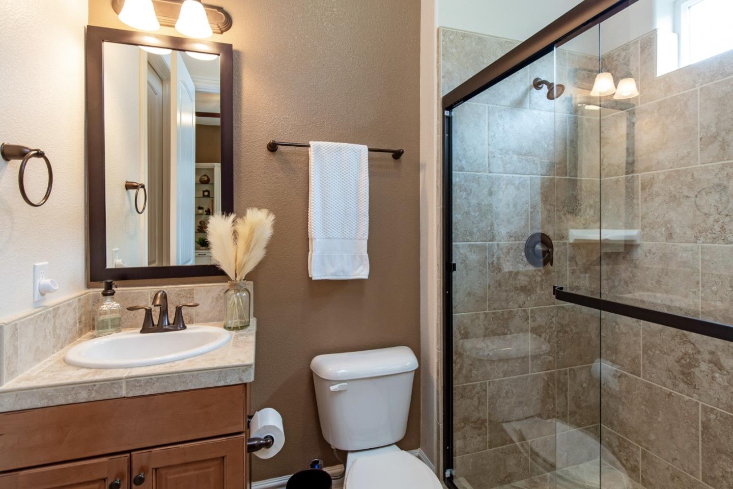 7217 Pitlochry Drive Gilroy, CA 95020 - Photo 26 of 66 a bathroom with a sink toilet and shower