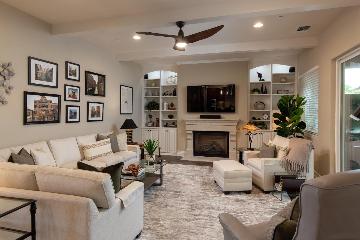7217 Pitlochry Drive Gilroy, CA 95020 - Photo 7 of 66 a living room with furniture a fireplace and a flat screen tv