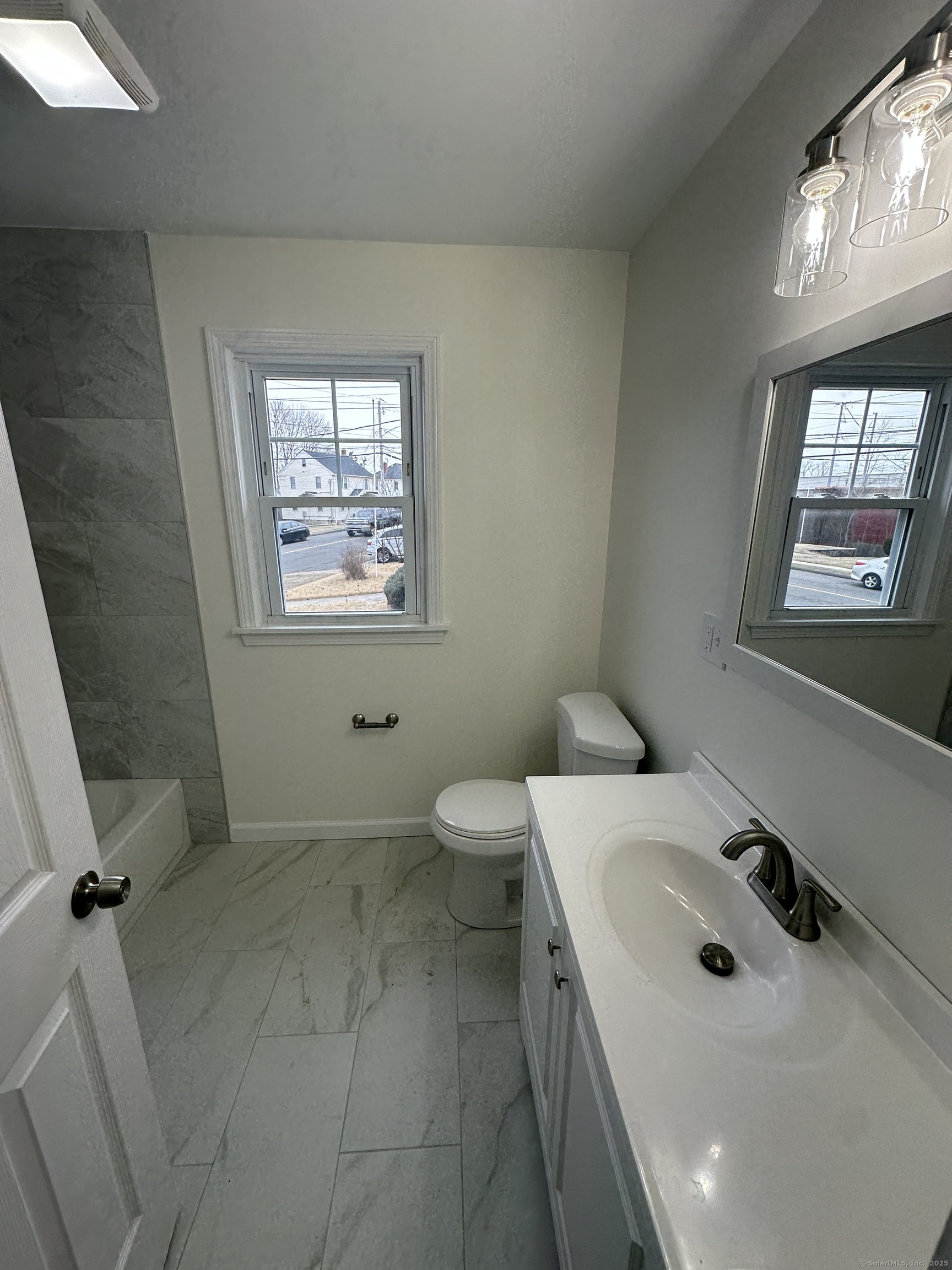 11 Colony Street Stratford, CT 06615 - Photo 12 of 16 a bathroom with a sink a toilet and mirror