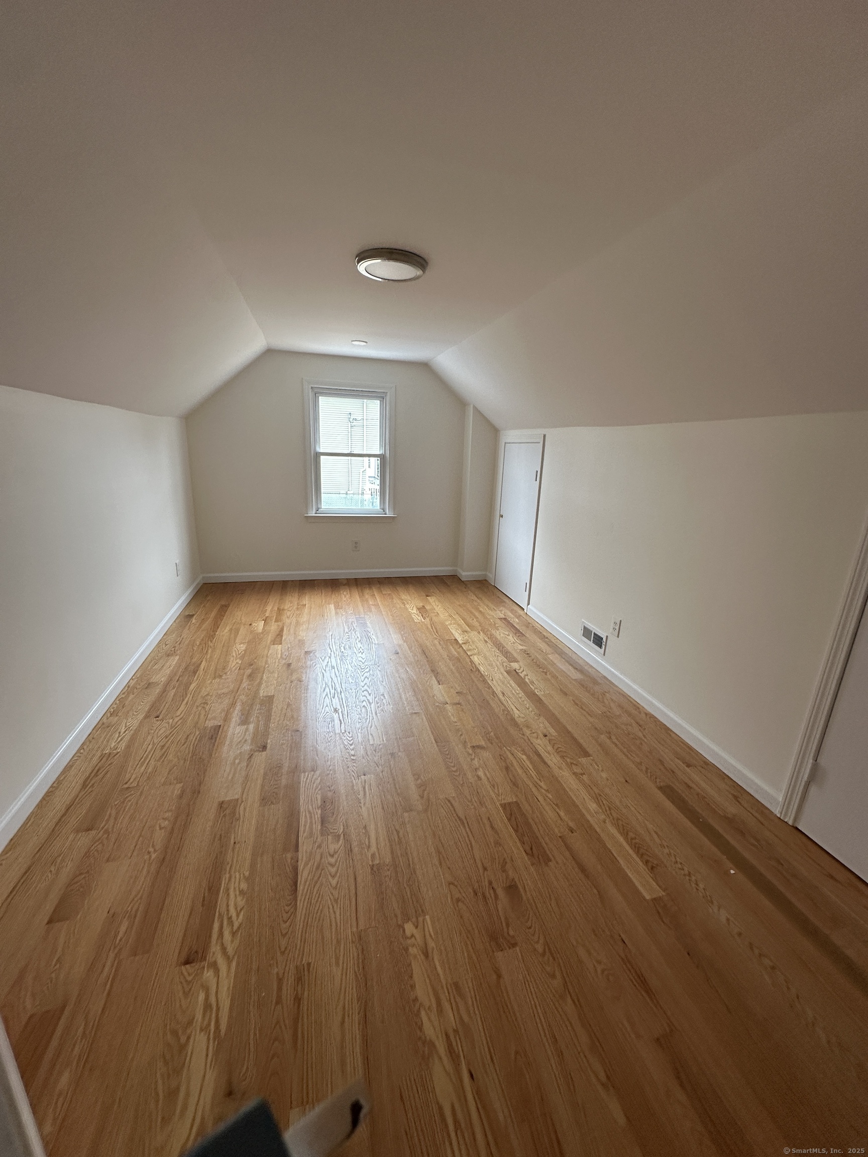 11 Colony Street Stratford, CT 06615 - Photo 13 of 16 an empty room with wooden floor and windows