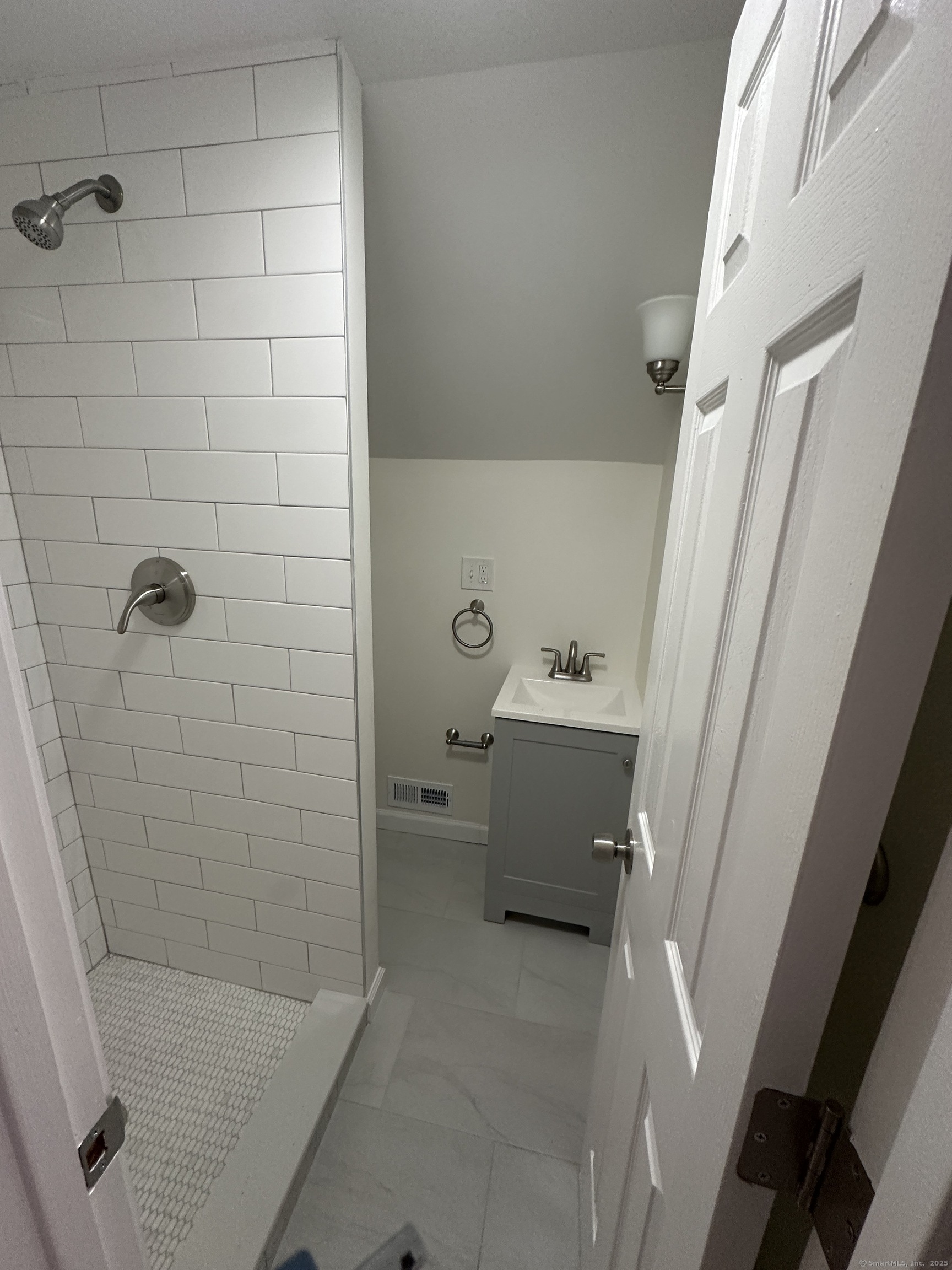 11 Colony Street Stratford, CT 06615 - Photo 14 of 16 a bathroom with a sink a toilet and shower