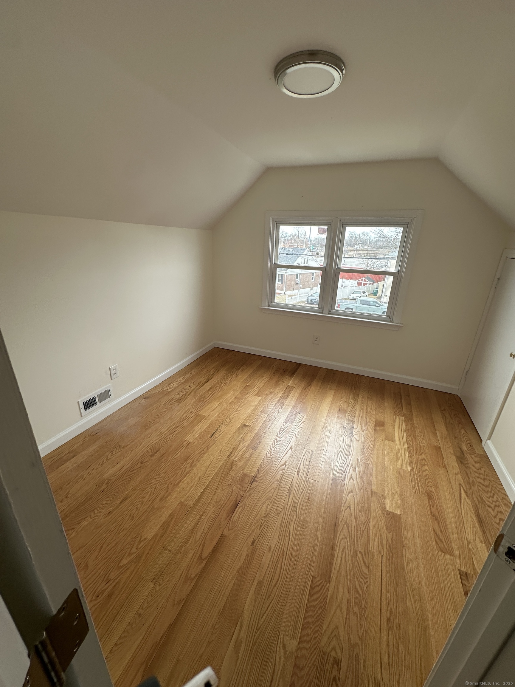 11 Colony Street Stratford, CT 06615 - Photo 15 of 16 an empty room with wooden floor and windows
